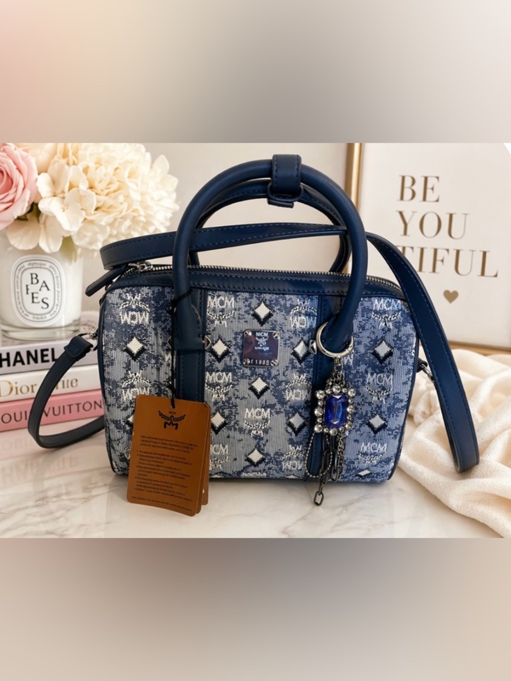 MCM Denim Barrel bag features leather trim and top handles